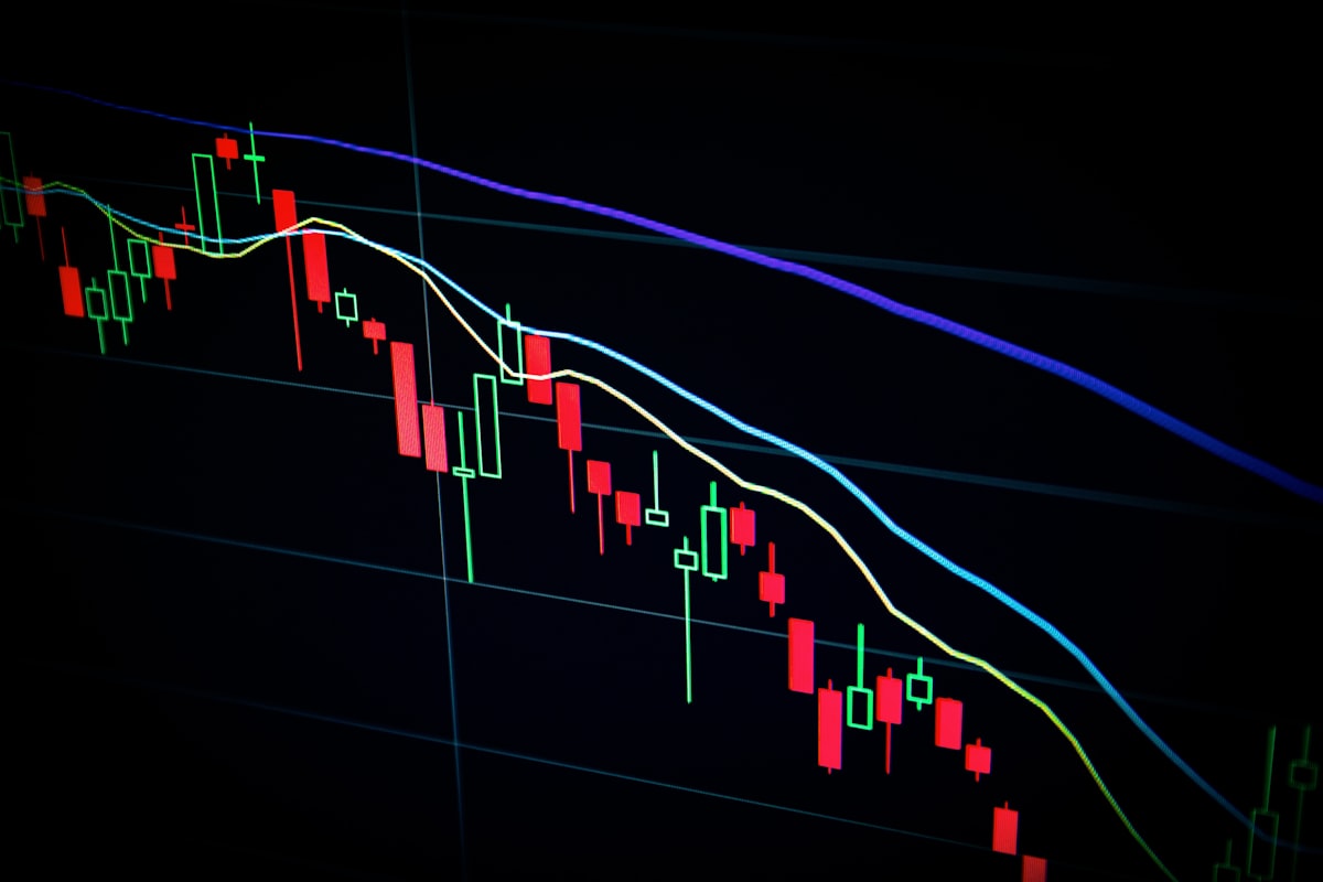 Crypto trading platform interface on laptop and smartphone showing live price charts and order books