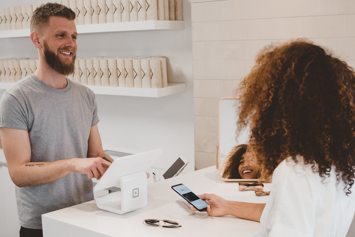 Traveler booking hotel on smartphone with cashback rewards and money icons floating around