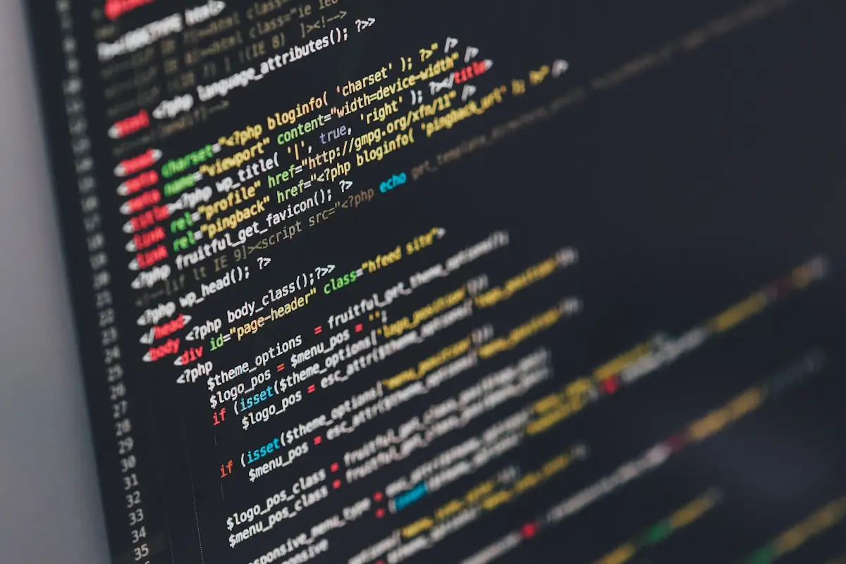 Developer comparing AI coding assistants Claude and ChatGPT on dual monitors with code on screen