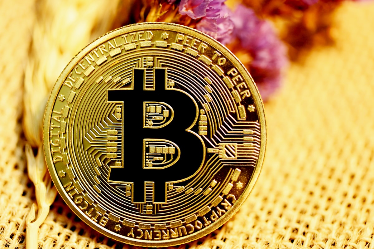 Person examining cryptocurrency faucet website on laptop with Bitcoin and security symbols
