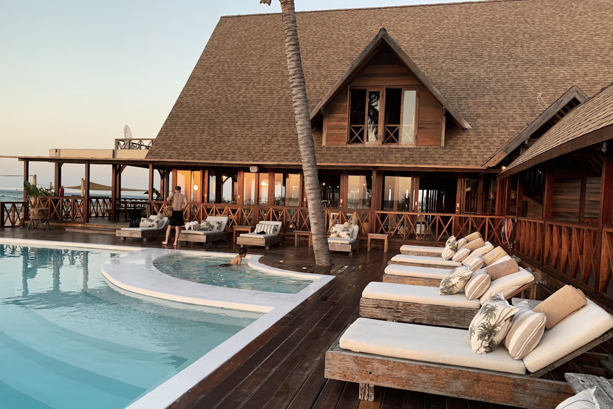 Luxurious hotel room with ocean view and traveler using laptop to book discounted accommodation
