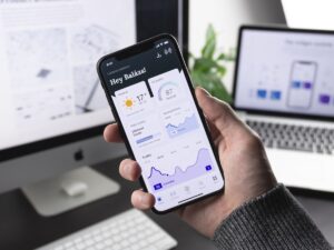 Developer using visual drag and drop no-code app builder on computer screen to create mobile application