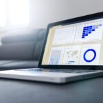 SEO expert analyzing Google search rankings on computer with analytics charts and keyword data