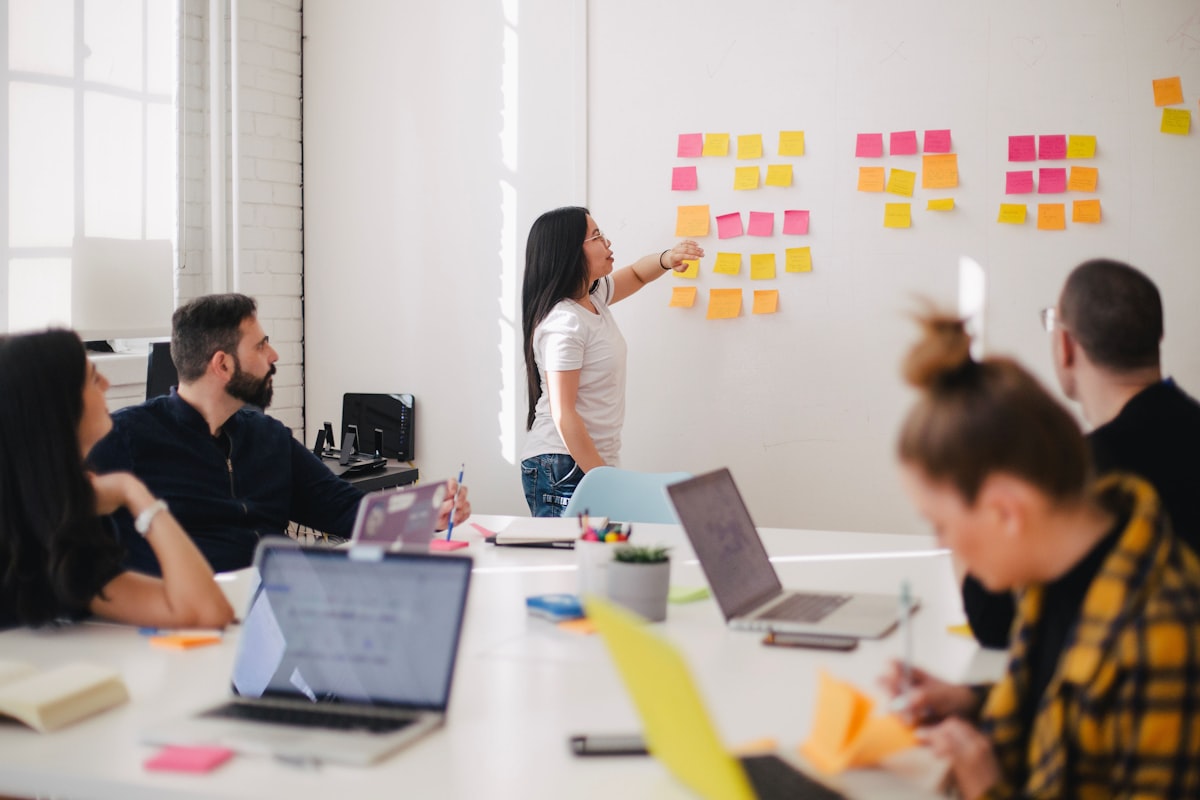 Marketing team brainstorming viral campaign ideas with colorful sticky notes and digital screens
